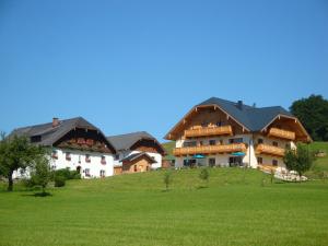 a large building on top of a green field at Urlaub am Dichtlhof in St. Wolfgang