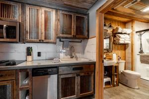 a kitchen with wooden cabinets and a sink and a toilet at Bunkhouse in West Yellowstone