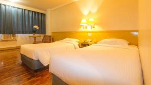 Postel nebo postele na pokoji v ubytování Aloha Hotel Roxas Boulevard Manila