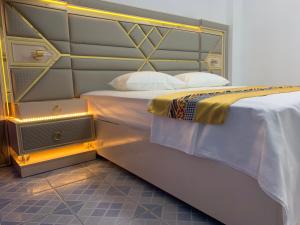 a bedroom with two beds and a headboard at Ontrack Travel Transit Hotel in Male City