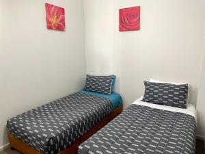 two beds sitting next to each other in a room at Hamilton in Emu Bay