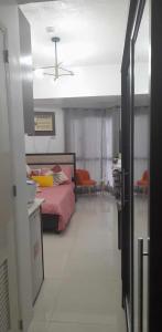 a bedroom with a bed and a ceiling fan at Grand Riviera Suites, US Embassy Comfy, Affordable Studio in Roxas Blvd, Ermita Manila in Manila