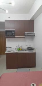 a kitchen with a sink and a microwave at Grand Riviera Suites, US Embassy Comfy, Affordable Studio in Roxas Blvd, Ermita Manila in Manila