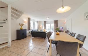 a dining room and living room with a table and chairs at Oesterbaai 8 Personen in Wemeldinge