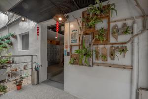 a room with potted plants on the wall at Light Hostel in Chiayi City