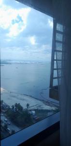 a view of the ocean from the window of an airplane at US Embassy Roxas Blvd, Ermita, Manila 1 Bedroom ComfySuite in Manila