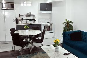 a kitchen with a table and a blue couch at DIAMOND PLACE in Brampton