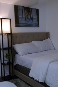 a bedroom with two beds and a lamp at DIAMOND PLACE in Brampton