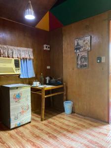 a kitchen with a counter and a table in a room at Casa de Corazon in Kandabong