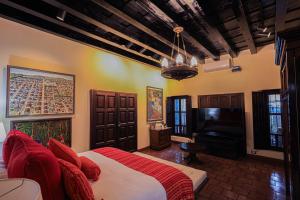 a bedroom with a bed and a flat screen tv at Hotel Casa Bansley in Antigua Guatemala