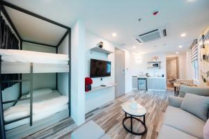 a room with bunk beds and a living room at Su Casa Hanoi Old Quarter in Hanoi