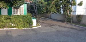 an empty street in front of a house at Cliff Apartment in Kingston