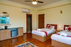 Voodi või voodid majutusasutuse Lumbini Five Elements Hotel toas
