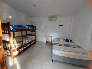 a bedroom with two bunk beds and a tiled floor at Alojamiento villa maría in Coveñas