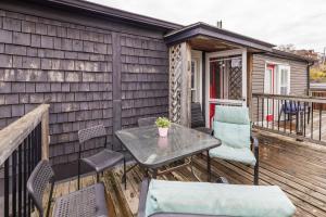 a patio with a table and chairs on a deck at 2BR Apartment with Private Rooftop Terrace in Ottawa