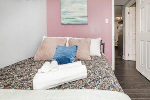 a bedroom with a white couch with pillows at 2BR Apartment with Private Rooftop Terrace in Ottawa