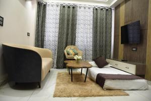 a bedroom with a bed and a chair and a table at 2BHK luxury Escape in rishikesh in Rishīkesh