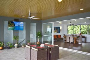 Aroha Seaview Villa - Private Pool - في بانتايْ سينانج: غرفة معيشة مع مروحة سقف وغرفة طعام