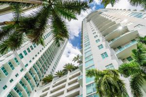two tall white buildings with palm trees in the foreground at Stylish 3 bed/2 bath 2 story in Miami