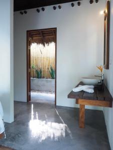 a bathroom with a sink and a wooden table at Inhale @ Hill in Ko Mook