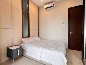 a small bedroom with a bed and a mirror at Dorsett Residences Bukit Bintang in Kuala Lumpur