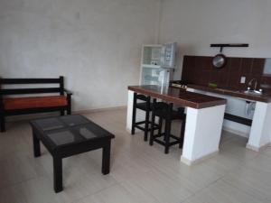 a kitchen with a counter and a table and a stove at La Terraza-Departamento 5- Parras de la Fuente in Parras de la Fuente