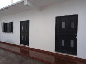 two doors on the side of a white building at La Terraza-Departamento 5- Parras de la Fuente in Parras de la Fuente