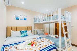 a bedroom with a bunk bed with a ladder at Ocean Pool Villa Pattaya in Bang Sare