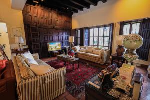 a large living room with couches and a tv at Hotel Casa Bansley in Antigua Guatemala