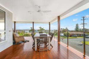 a dining room with a table and views of the ocean at Topviews 15 Second Av BH in Bonny Hills