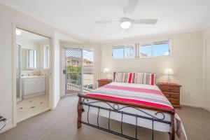 a bedroom with a bed and a window at Topviews 15 Second Av BH in Bonny Hills