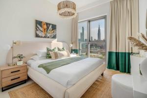 Postel nebo postele na pokoji v ubytování GuestReady - Serenity Overlooking Burj Khalifa
