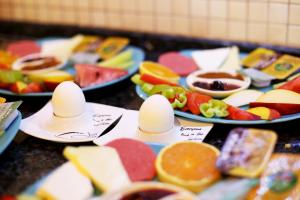 a bunch of different types of fruit on plates at Rose Hotel B&B in Patara
