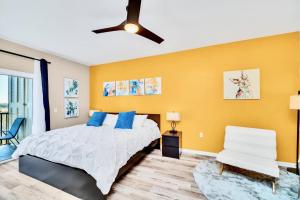 1 dormitorio con cama y pared amarilla en Bright Condo, near Disney!, en Orlando