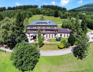 an aerial view of a large house on a hill at Alpský Hotel in Špindlerův Mlýn