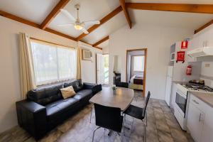a living room with a couch and a table at BIG4 Breeze Holiday Parks - Eildon in Eildon