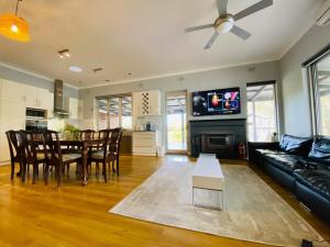 a living room with a couch and a table at The Gabby's Holiday House in Nuriootpa