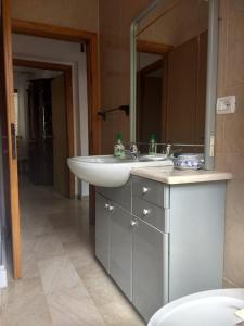 a bathroom with a sink and a mirror at Casa Vacanze Arba Girasole in Girasole
