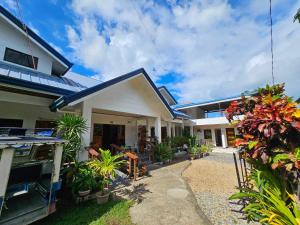 a house with plants in front of it at Bella Vita Guest House in Coron