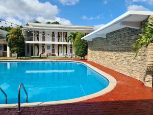 an image of a swimming pool in front of a house at My Place Resort & Pavilion in Balayan