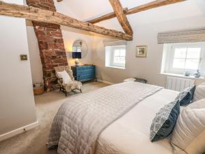 a bedroom with a bed and a blue dresser at Croft Cottage in Long Marton