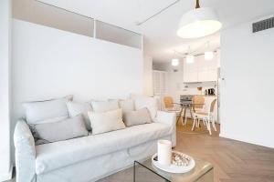 a white living room with a white couch and a table at Stylish 1BR Haven in Bondi Junction in Sydney