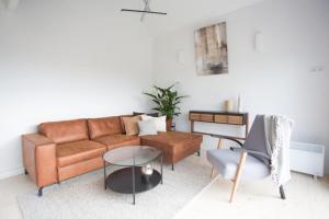 a living room with a couch and a table at Green corner in Krakow