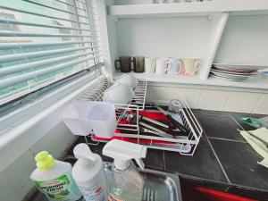 a kitchen with a dish drying rack in a refrigerator at Kaban Power 6 in Doonside