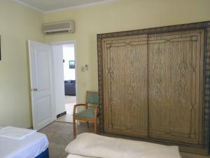 a large wooden closet in a room with a chair at Naama Bay, 2BR Pool and sea view, Center Naama Bay Sharm El-Sheikh in Sharm El Sheikh