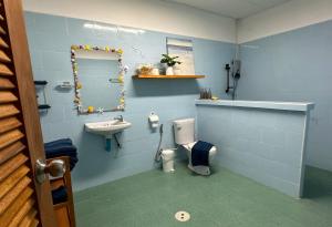 a blue bathroom with a sink and a toilet at Bonneville Beach House in Thai Muang +9 photos