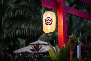 a light that is attached to a red pole at Timba Garden FREE TOWN AND JETTY TRANSPORT in Semporna