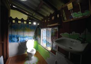 a bathroom with a toilet and a sink at ภูทรายแก้วรีสอร์ทวังน้ำเขียว in Wang Nam Khieo