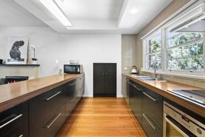 a kitchen with a long counter and a window at Sea Corner in Anglesea