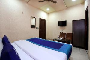 a bedroom with a bed and a tv in it at OYO 9808 Hotel Prem Sagar in Ludhiana